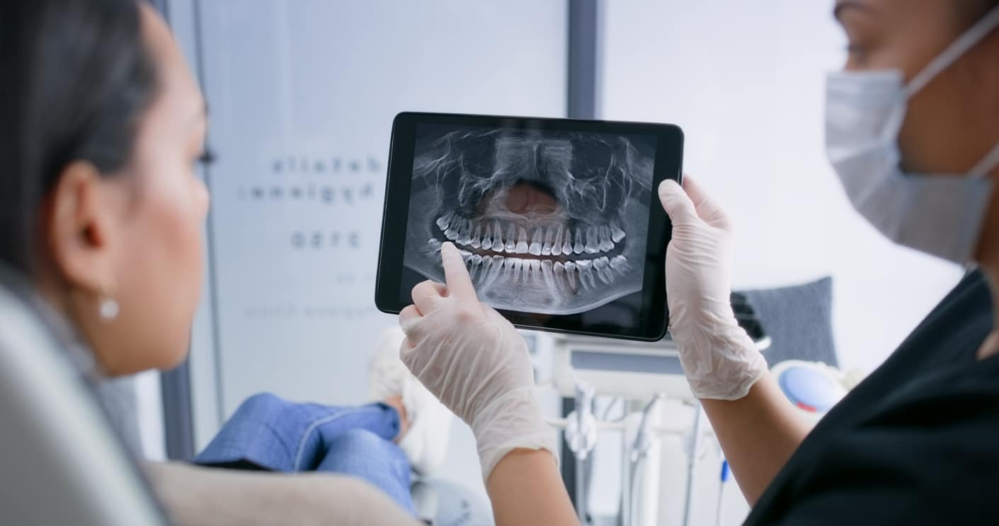 Dentist explains x-rays to a patient